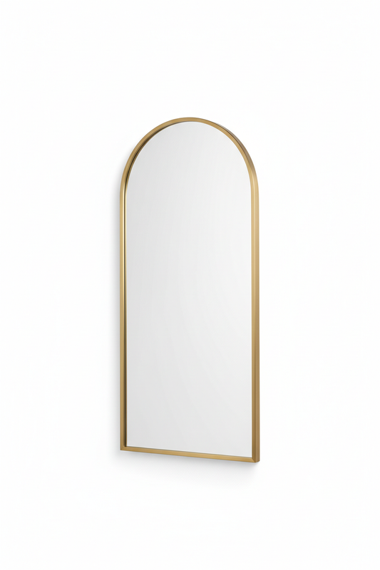 Arched brass wall mirror with gold frame on white background